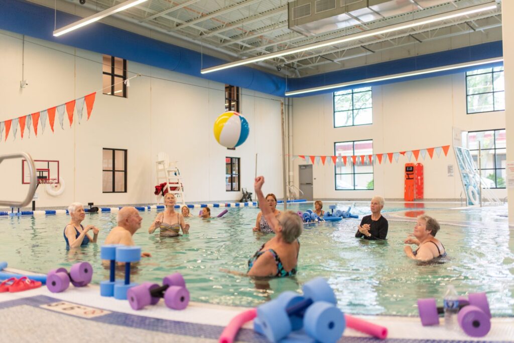 people playing with a ball in a pool.